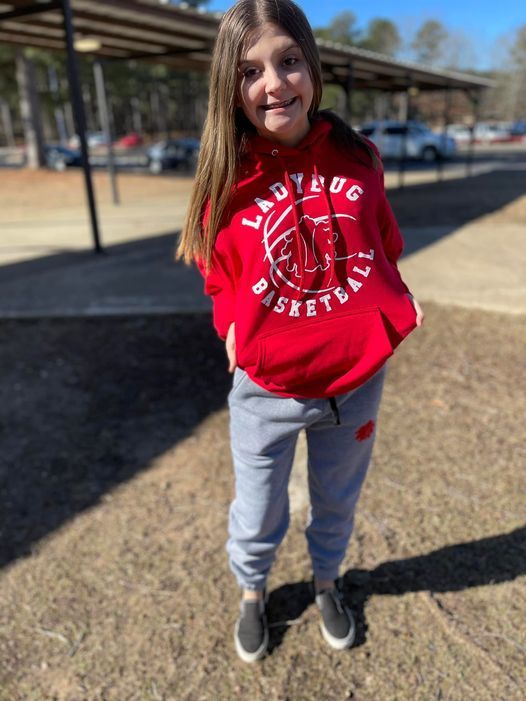 student wearing new redbugs red hoodie