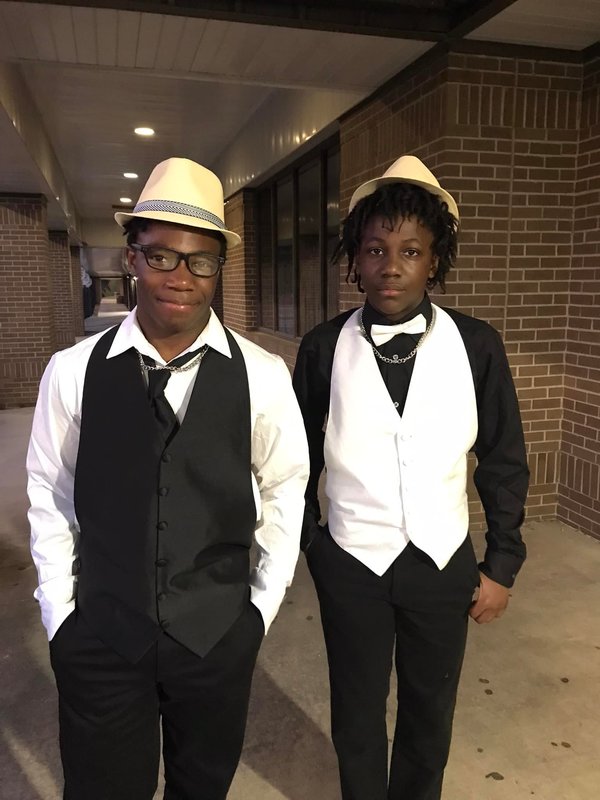 students at spring fling dance in tuxedos and fedoras
